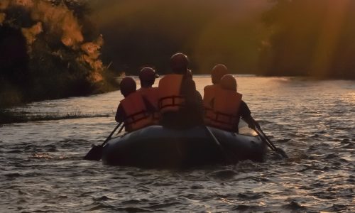 river rafting at sunset